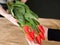 Flower delivery florist handing red tulip bouquet