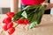 Flower delivery florist holding red tulip bouquet