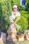 Flower Festival. Mature woman among pots with arborvitae and pottery