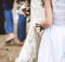 Flower girl holding brides wedding dress