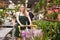 Flower market. Seller delivers potted flowers on a pushcart