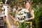 Flower market. Seller delivers potted flowers on a pushcart