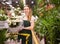 Flower market. Seller delivers potted flowers on a pushcart