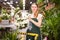 Flower market. Seller delivers potted flowers on a pushcart