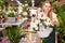 Flower market. Seller delivers potted flowers on a pushcart