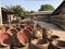 Flower pots well arranged on ground.