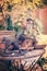 Flower pots and wooden horse ornaments on a rusty metal table in a garden in autumn