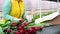 flower seller or a florist collects flower arrangements on the background of bouquets of tulips. Spring Festival
