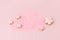 Flower shape cookies anf confettic on pink pastel background. Tender holiday concept - Saint Valentine, Woman, Mother day, Easter