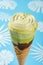 flower shape matcha flavor ice cream cone on a blue background with flowers and leaves paper cuttings