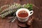 Flower tea with mint on an old wooden table, has a calming and relaxing effect, alternative medicine concept