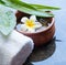 Flower, towel and stones treatment on dark background