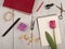 Flower tulip, note pad, book, scissors, nail polish and buttons