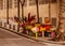 Flower vendor counter at the corner of the street, warm daylight afternoon, nobody but colorful flowers. empty street.