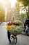 Flower vendor on Hanoi street at early morning with St. Joseph Cathedral church on background