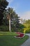 The flowerbed, lawn and path in a park