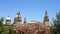 Flowerbed on the Montjuic mountain with the upper part of the domes of the National Palace of Catalunya