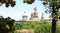 Flowerbed on the Montjuic mountain with the upper part of the domes of the National Palace of Catalunya