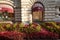 Flowerbeds with begonias and various types of coleus in red tones adorn the entrance to GUM on Nikolskaya Street