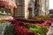 Flowerbeds with begonias and various types of coleus in red tones adorn the entrance to GUM on Nikolskaya Street