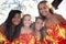 Flowered Beautiful Polynesian Hula girls smiling at camera