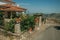 Flowered bushes in front of charming old house in Monsanto