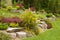 Flowering rock garden in spring. Different bushes and flowers bl