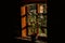 Flowerpot on the windowsill of a wooden old window in an old country house made of wood