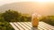 Flowerpot on wooden table on outdoor terrace. Beautiful seating with landscape mountains view while sunset