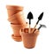 Flowerpots with gardening tools on white background