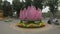 Flowers and abstract light purple geometric installation in a traffic circle in hanoi, vietnam