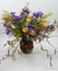 Flowers arrangement in a vase with irises and daffodils