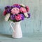 Flowers asters in white enameled pitcher