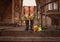 Flowers in boots. girl in a white dress on the steps of a wooden house.