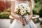 Flowers in bouquet. Bride holding white flowers in wedding bouquet close up