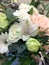 Flowers bouquet closeup. Decoration made of roses, white amarilis and decorative plants, close-up. Summer Background