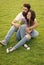 Flowers brighten day. Bearded man give flowers to sexy woman. Couple in love relax on green grass. Flower shop. Holiday