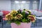 Flowers composition on table in empty conference room, office