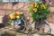 With flowers decorated bicycle parked against a wall of a greenhouse