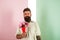 Flowers delivery concept. Man with beard calm face holds bouquet fresh flowers. Delivery man with flowers. Hipster with