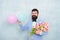 Flowers delivery. Gentleman romantic date. Birthday greetings. Confidence and charisma. Man bearded gentleman suit bow