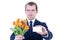 Flowers delivery - young man in business suit holding tulips and