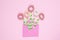 Flowers from hair spiral scrunchies on pink background