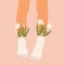 Flowers and leaves in socks on a pair of female legs. Summer bouquet aesthetic. Blossoms and high socks. Modern floral