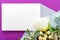 Flowers mock up wedding invitation. Congratulations card in bouquet of white flowers tulips, eucalyptus on purple background.
