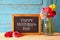 Flowers next to blackboard. happy mother\'s day concept