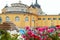 Flowers petunia on the background of Szechenyi Baths. Budapest thermal bath. Hungary