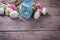 Flowers in pink colors and candle in blue lantern on vintage w