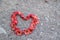 Flowers placed in a heart shape on the sand