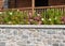 Flowers and plants in a stonewall planter, garden